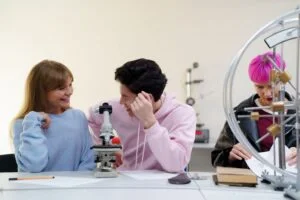 A group of students interacting and conducting experiments in a science lab, showcasing teamwork and learning.