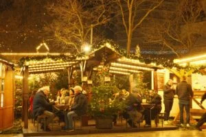 Experience the festive atmosphere of Berlin's Christmas market with lights, decor, and merry gatherings.